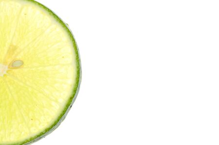Green lemon slice backlit on white backgroundの写真素材