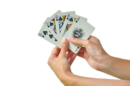 Playing cards in hand isolated on white backgroundのeditorial素材
