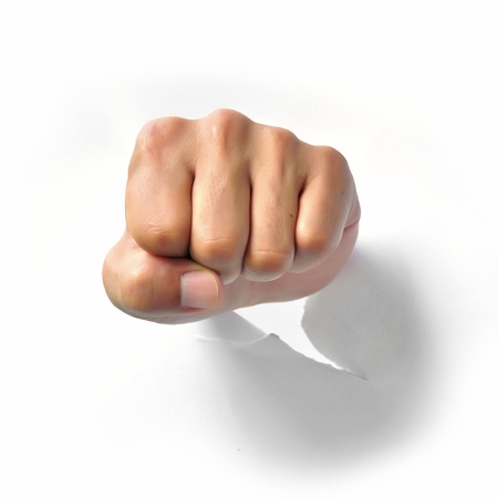 Fist punching paper isolated on white background の写真素材