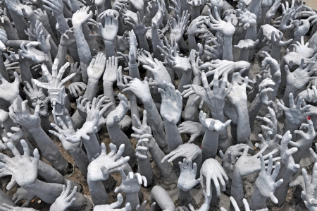hands reaching out, sculpture at Wat Rong Khun, the white temple near Chiang Rai, Thailand の写真素材