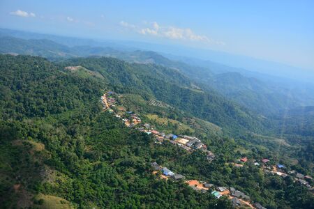 Village on green forests mountain in Lampang Province Thailand with a bird's-eye view.の写真素材