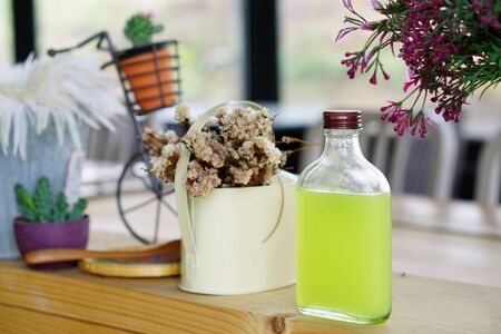 Bottle of Punch Lemon Juice with Soda served in Ice Bucket - Summer Cocktail or Tropical Mocktail.の写真素材