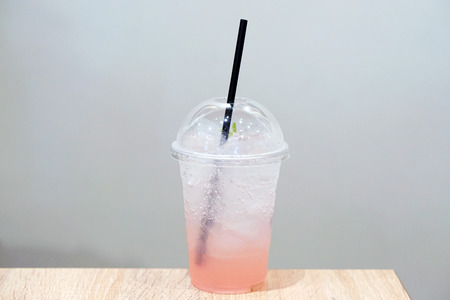 Closeup of Rose Italian Soda with lychee and lemon on wooden table, Summer Cocktail or Tropical Mocktail.の写真素材