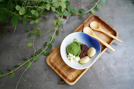 A bowl of homemade matcha ice cream (green tea latte ) served with red bean and mochi. Traditional Japanese dessert.の写真素材