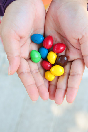 color sweets in woman handの写真素材