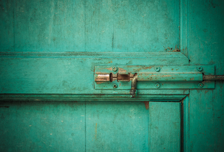 close up of dusty latch on Blue backgroundの写真素材