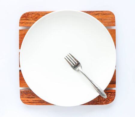 white empty dish with fork on white backgroundの写真素材