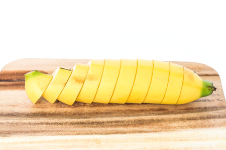 banana slice put on wood on white backgroundの写真素材