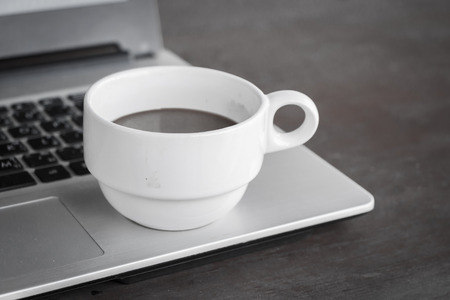 coffee cup put on laptopの写真素材