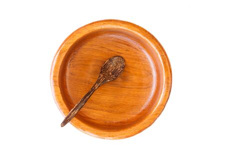 Empty wooden plate with wooden spoon isolated on white background.の写真素材