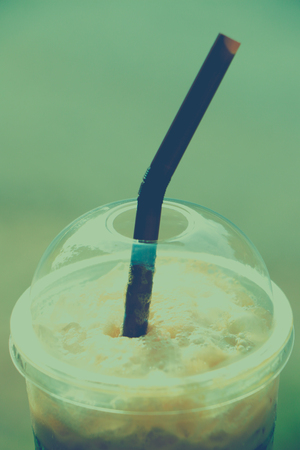 Iced coffee in plastic cup with vintage tone styleの写真素材