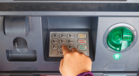 ATM close-up with woman handの写真素材