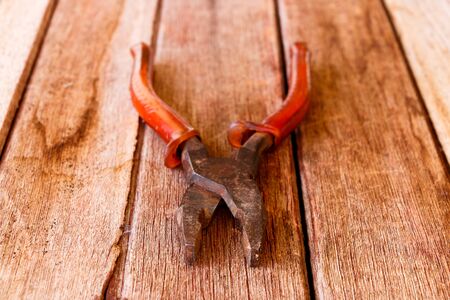 Pliers put on wooden table.の写真素材