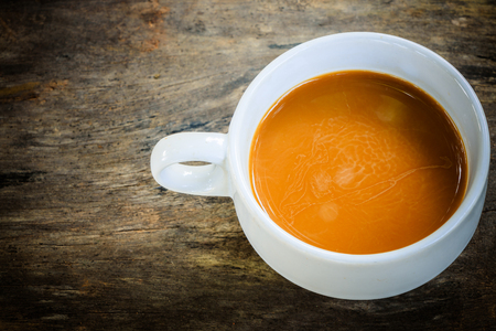 cup of coffee on old wood backgroundの写真素材