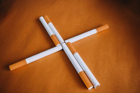 cigarettes with filter on brown background