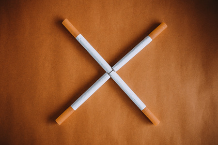 cigarettes with filter on brown backgroundの写真素材