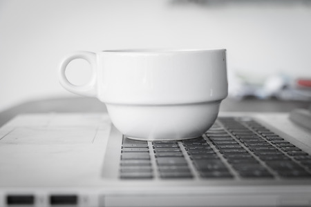 coffee cup put on laptopの写真素材