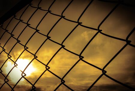 seamlessly tillable chain link fence with park in backgroundの写真素材