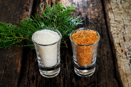 Brown sugar close-up in small glass on wooden tableの写真素材