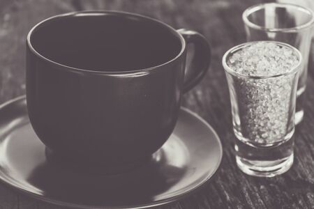 Cup of coffee close-up with tablet and sugar in glass, vintage tone style.の写真素材