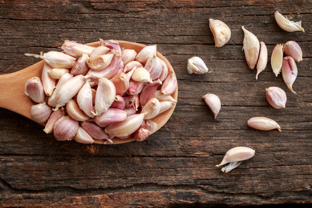 Garlic on old wooden backgroundの写真素材