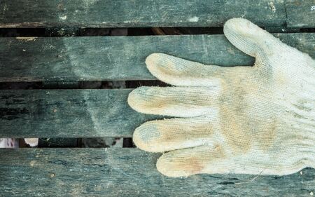 Construction gloves on woodenの写真素材