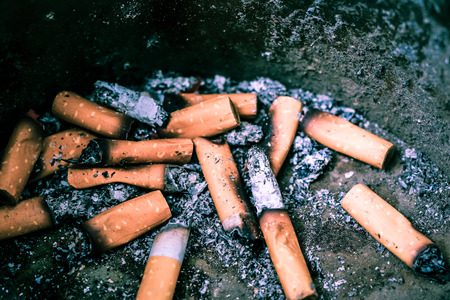 Bad addiction. Ashtray and cigarettes close-up.の写真素材