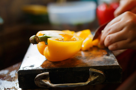 female's hand cutting vegetable for making foodの写真素材