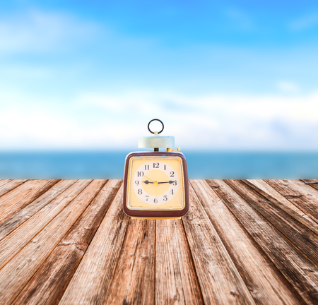 Vintage clock put on coconut plank under imageの写真素材