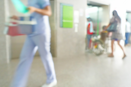 Blurred image of unidentified people and patient waiting doctor or medicine in hospital.の写真素材