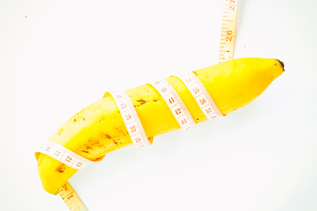 Banana wrapped up with Measure Tapeの写真素材