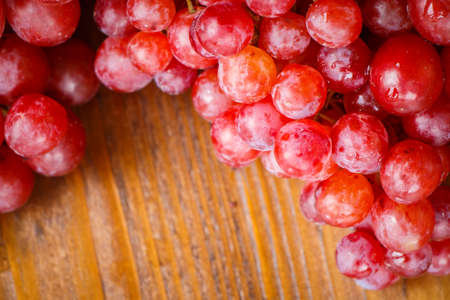 Red grape on wooden table, Healthy concept.の写真素材