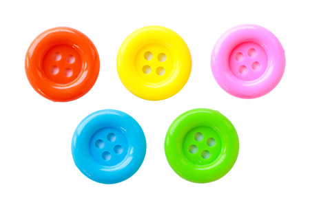 Colorful sewing buttons on white background.