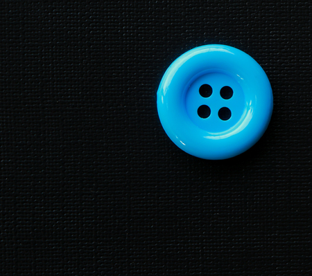 Close-up colorful sewing button on black background.の写真素材