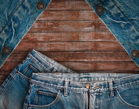 vintage denim jean put on wooden background, denim texture, denim textile, denim background.の写真素材