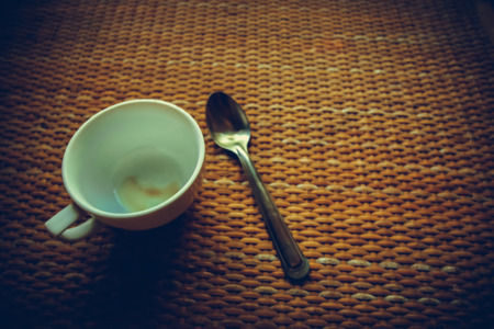 Blank cup of coffee put on old bamboo desk with vintage tone style.の写真素材