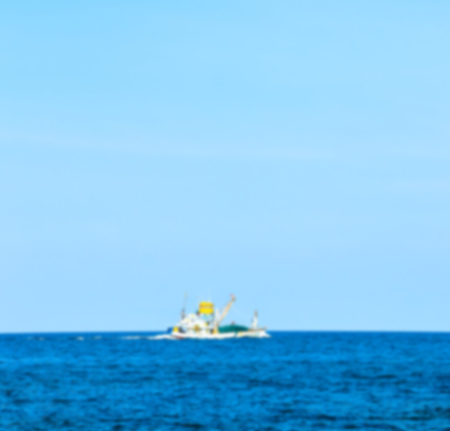 Abstract blurred of boat at the sea with blue sky backgroundの写真素材
