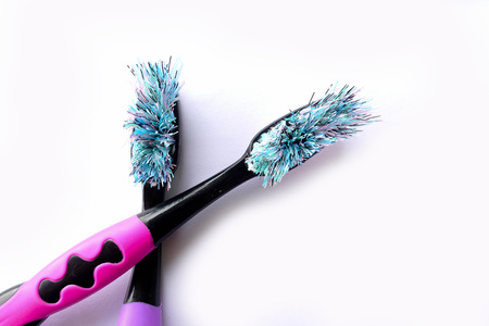 Old toothbrush isolated on white background