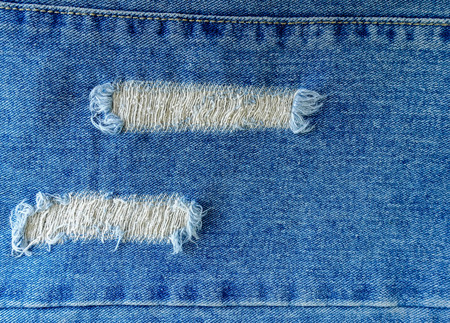Old vintage denim torn texture backgroundの写真素材