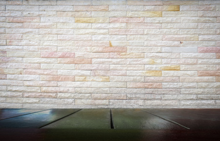 wooden table under with cement brick background for add productsの写真素材