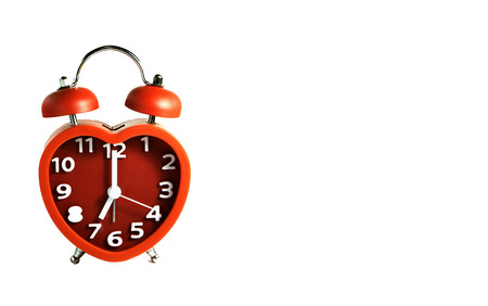 Red alarm clock put on white background