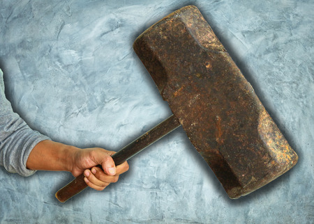 Aggressive human hand holding hammerの写真素材