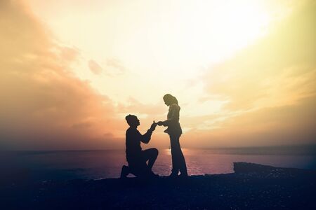 silhouette of woman and man holding hand with sunset on the beach and sea background, Love concepts.