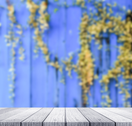 Abstract blurred of rustic wall with dirty plant and soft wooden tabletop use for products or...