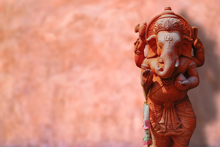 An image of a ganesha elephant god statue sculpture with old cement backgroundの写真素材