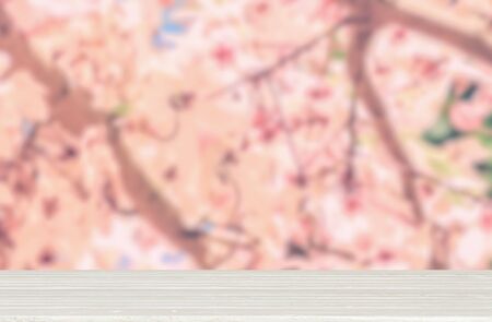 Wooden table top with nature flower blurred background