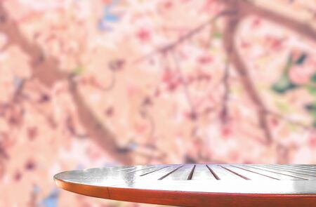 Wooden table top with nature flower blurred background
