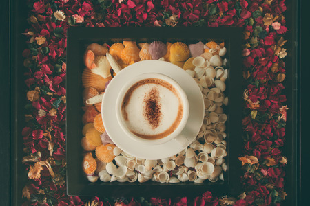 Cappuccino cup on the table with vintage filter toneの写真素材