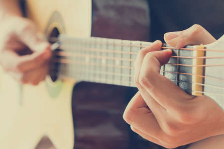 Close up human hand show playing guitar