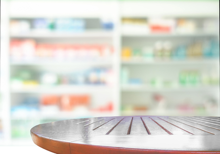 Wooden tabletop for products display with blurred of drugs store backgroundの写真素材